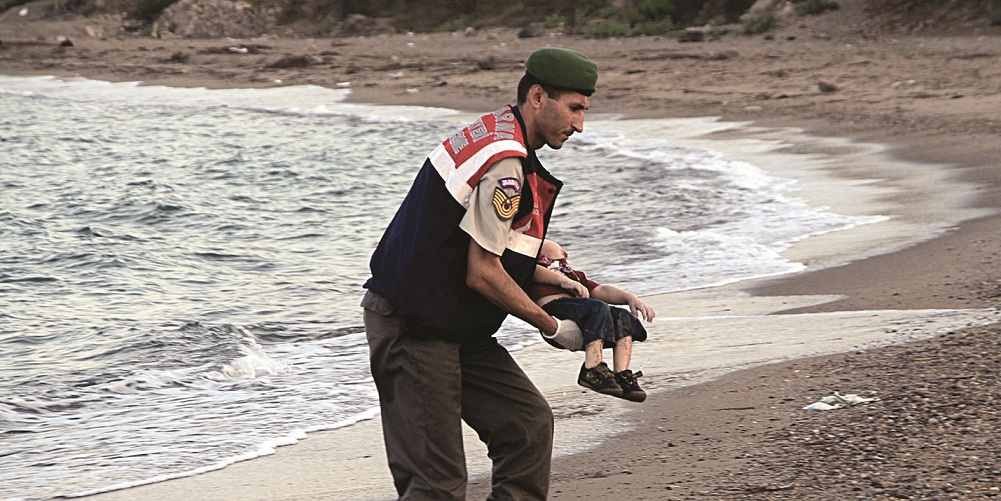 ADDS IDENTIFICATION OF CHILD   A paramilitary police officer carries the lifeless body of Aylan Kurdi, 3, after a number of migrants died and a smaller number were reported missing after boats carrying them to the Greek island of Kos capsized, near the Turkish resort of Bodrum early Wednesday, Sept. 2, 2015. The family â Abdullah, his wife Rehan and their two boys, 3-year-old Aylan and 5-year-old Galip â embarked on the perilous boat journey only after their bid to move to Canada was rejected. The tides also washed up the bodies of Rehan and Galip on Turkey's Bodrum peninsula Wednesday, Abdullah survived the tragedy. (AP Photo/DHA) TURKEY OUT