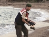 ADDS IDENTIFICATION OF CHILD   A paramilitary police officer carries the lifeless body of Aylan Kurdi, 3, after a number of migrants died and a smaller number were reported missing after boats carrying them to the Greek island of Kos capsized, near the Turkish resort of Bodrum early Wednesday, Sept. 2, 2015. The family â Abdullah, his wife Rehan and their two boys, 3-year-old Aylan and 5-year-old Galip â embarked on the perilous boat journey only after their bid to move to Canada was rejected. The tides also washed up the bodies of Rehan and Galip on Turkey's Bodrum peninsula Wednesday, Abdullah survived the tragedy. (AP Photo/DHA) TURKEY OUT